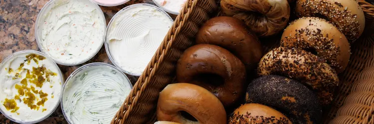 Fresh bagels with tubs of cream cheese