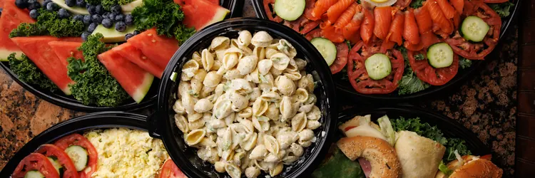 Catering platters: fruit, smoked nova, pasta salad, deli salad and sandwiches