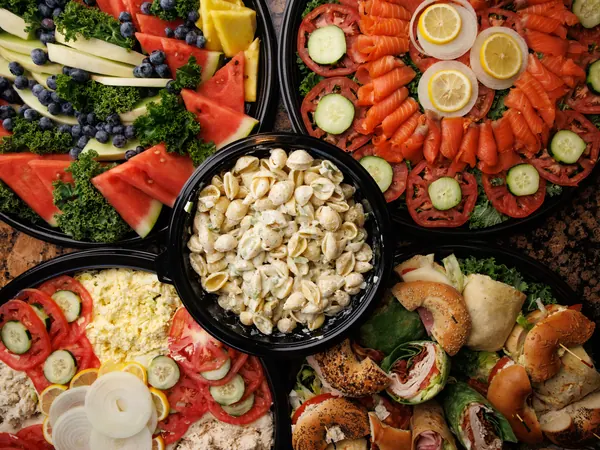 Bagel Boyz catering platters: fruit, smoked nova, deli salad, pasta salad and sandwiches