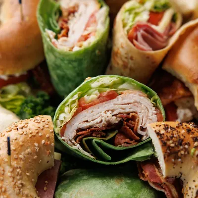 Cut wraps and bagel sandwiches from a sandwich platter