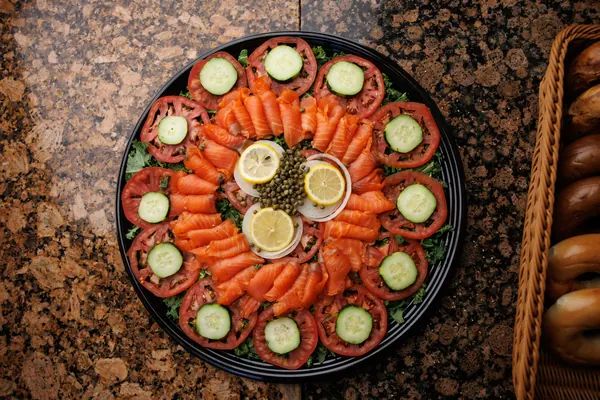 Smoked nova platter with tomato, cucumber, onion, lemon and capers